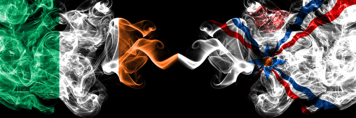 Republic of Ireland, Irish vs Assyria smoky mystic flags placed side by side. Thick colored silky abstract smoke flags.