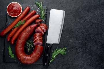 Two types of salami sausages with spices on a stone background .Top view with copy space for your text