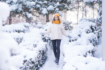 Wall Mural - Portrait of a happy smiling girl on a snowy winter day