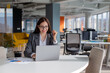 © Red Riding Hood - Young smiling businesswoman working at the laptop in open space office.