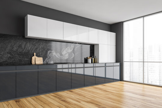 Black and white kitchen set with appliances on parquet floor