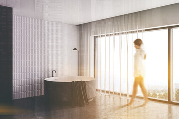 Woman walking in white and gray bathroom corner