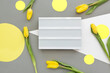 Spring decoration, womens day, mothers day concept, yellow tulips, light box with free space for text. Illuminating Yellow, Ultimate Gray, colors of the year 2021. Layered paper flatly.