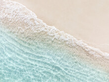Aerial Top View Of Beautiful Tropical White Sand Beach With Wave Foam And Transparent Sea, Summer Vacation And Travel Background With Copy Space, Top View From Drone