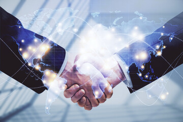 Double exposure of business theme hologram and handshake of two men. Success concept.