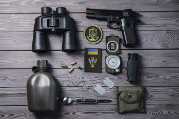 Wall Mural - Flat lay composition with Ukraine military equipment on grey wooden table