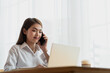 © surachetkhamsuk - Young Asian businesswoman working at her house with laptop, working at home, business concept