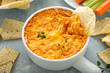 © fahrwasser - Buffalo chicken dip served with chips and fresh vegetables