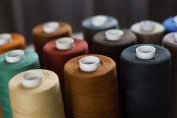 Spool of sewing thread. reels of threads for sewing. Spools of Thread. Pile of cotton reels. Bobbins with colorful threads. Color sewing threads. Needlework, handmade. Close-up horizontal format