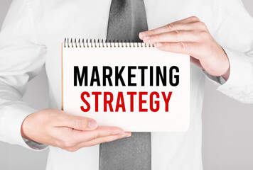 Poster - Businessman with notebook with text Marketing Strategy