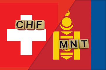 Switzerland and Mongolia currencies codes on national flags background