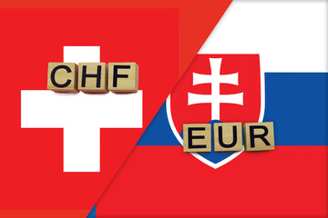 Switzerland and Slovakia currencies codes on national flags background