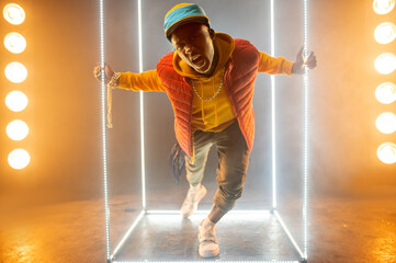 Wall Mural - Stylish rapper on the stage with illuminated cube