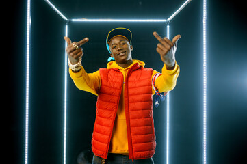 Wall Mural - Smiling rapper on the stage with illuminated cube