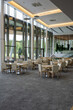 © pressmaster - Interior of five star restaurant inside modern business center with many tables