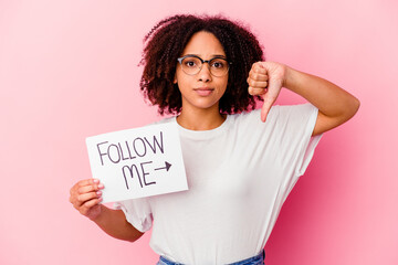 Young african american mixed race woman holding a follow me concept showing a dislike gesture, thumbs down. Disagreement concept.