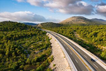 Wall Mural - aerial view on road. highway throu mountain valley. view from a drone. natural landscape in summer t