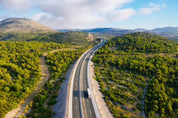 Wall Mural - aerial view on road. highway throu mountain valley. view from a drone. natural landscape in summer t