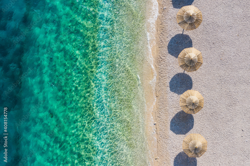 Mediterranean sea. Aerial view on the beach and umbrellas. Vacation and adventure. Coast and blue water. Top view from drone at beach and azure sea. Travel and vacation image. - obrazy, fototapety, plakaty 
