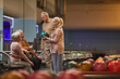© Seventyfour - Wide angle side view at group of senior people playing bowling together while enjoying active entertainment at bowling alley, copy space