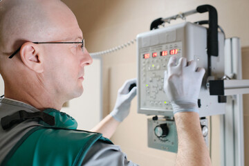 Wall Mural - Doctor using x-ray equipment at work