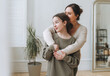 Portrait of mother middle age woman and daughter teenager together in thelight interior