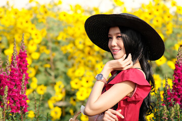 Wall Mural - Portrait of happy asian woman in the cockscomb flower garden and relaxing on holiday