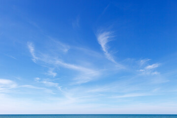 beautiful blue sky over the sea with translucent, white, cirrus clouds