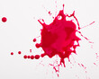 Splash and splatters of spilled paint of red color on white surface..