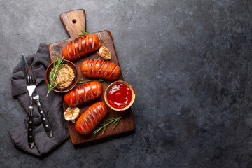 Canvas Print - Hot grilled sausages on wooden board