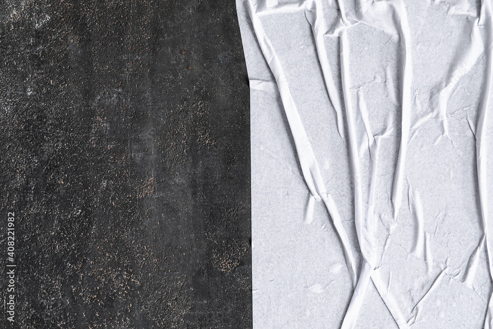 Texture of crumpled wet paper on dark background