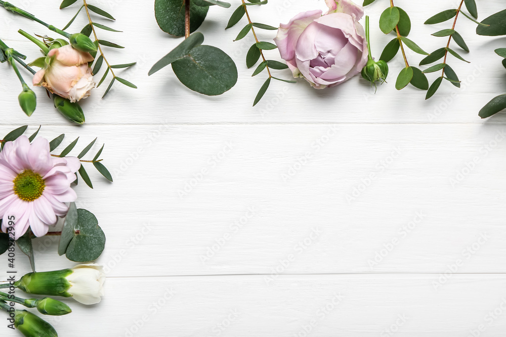 Beautiful flowers on white wooden background