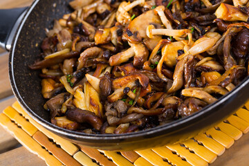 Close-up of delicious freshly cooked fried oyster mushrooms in a frying pan