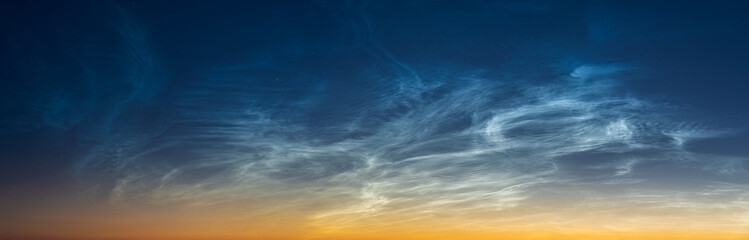 Wall Mural - panorama of the evening sky and spectacular silvery clouds