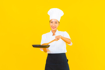 Wall Mural - Portrait beautiful young asian chef woman with black pan