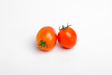 Red, bright, juicy, fresh tomatoes isolated on white background