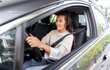 © Syda Productions - safety and people concept - happy smiling young woman or female driver driving car in city