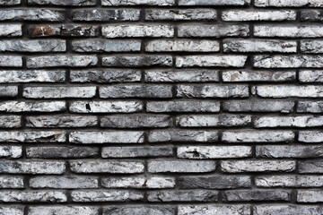 Gray grunge brick wall background. Dark stone texture for design.