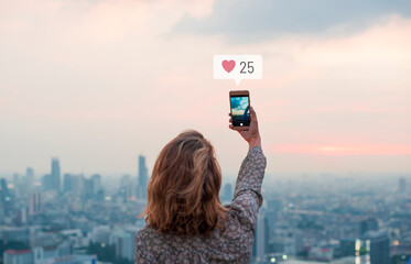 Sticker - Woman taking a photo of the sunset