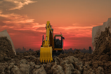 Excavators are digging the soil in the construction site on the  sunset  sky background