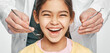© Peakstock - Smiling mixed race girl in a dental clinic for children. Child with a toothy smile during inspection of oral cavity by a dentist. Close-up