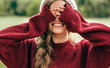 © iuricazac - Candid portrait of a gorgeous young woman smiling broadly covering her eyes with two hands in the park.