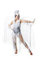 Wall Mural - Stylish. Beautiful young woman in carnival, stylish masquerade costume with feathers dancing on white studio background. Concept of holidays celebration, festive time, dance, party, fashion