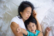 © TripleP Studio - Authentic close up of happy mother and her son in a bed. Concept of new generation, family, parenthood, authenticity, connection.