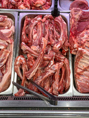 Wall Mural - Vertical photo of raw pork meat for sale at butcher stall