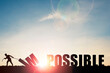 © Dilok - Mindset concept ,Silhouette man pulling  impossible to change possible wording on cloud sky and sunlight.