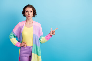 Poster - Photo portrait of shocked girl pointing finger looking at blank space isolated on pastel blue colored background