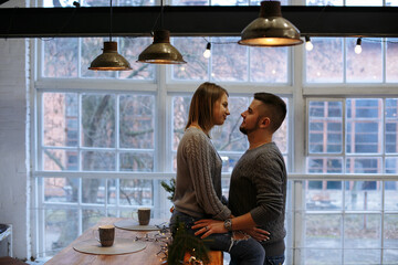 girl and guy in the kitchen hugging