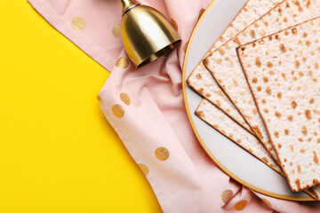 Plate with Jewish flatbread matza for Passover and cup on color background