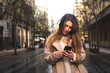 © Jorge Argazkiak - Young caucasian brunette woman using a smartphone at the street